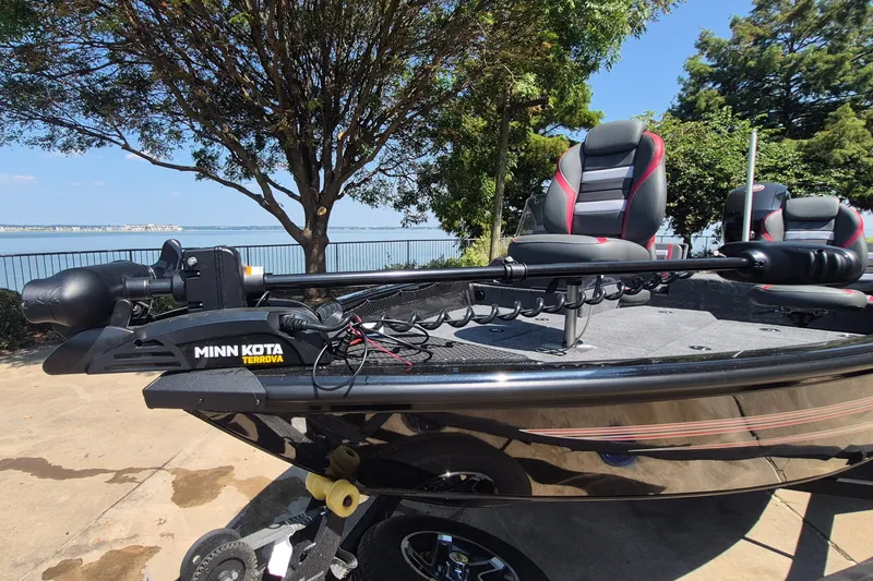 Slide: The Image of 2026 Ranger VS1782SC Reata boat with Minn Kota Terrova motor by a lakeside. - 2