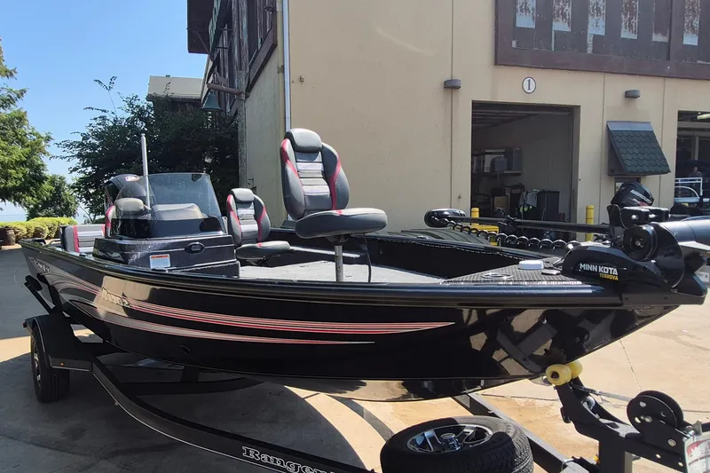 Slide: The Image of 2026 Ranger VS1782SC Reata boat with Minn Kota motor, parked outdoors. - 4