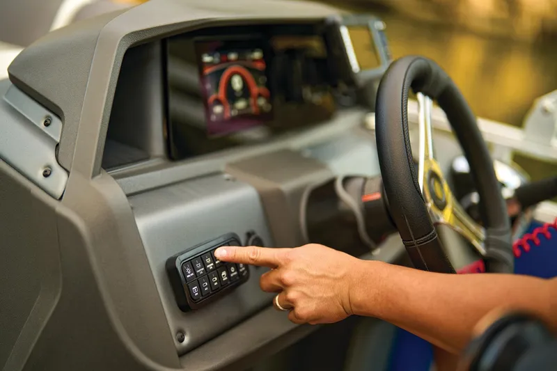 Slide: The Image of 2026 Sun Tracker Fishin' Barge 20 DLX livewell, open lid, gray interior, boat deck view. - 13