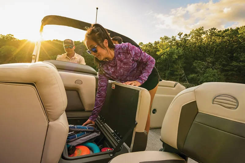 Slide: The Image of 2026 Sun Tracker Fishin' Barge 20 DLX interior with storage compartment and cup holder. - 17