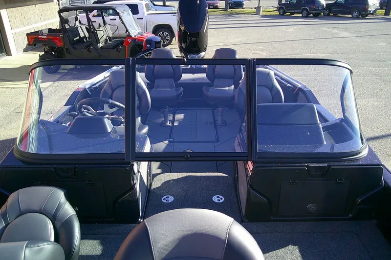 Slide: The Image of 2026 Nitro ZV21 Pro boat interior with seating and steering wheel, parked outdoors. - 10