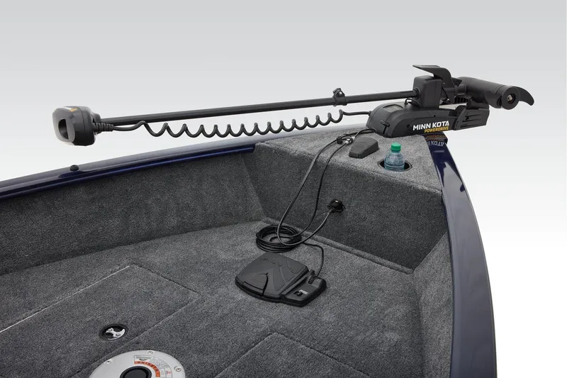 Slide: The Image of 2026 Tracker Super Guide V-16 T boat interior with gray seating and carpeted deck. - 8