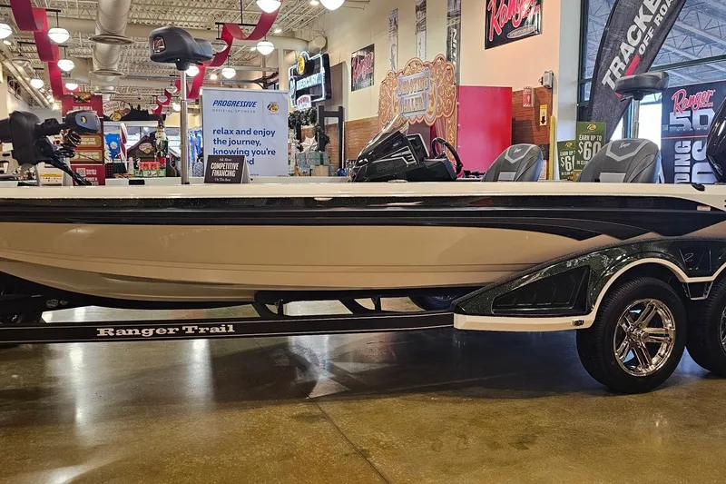 The Image of 2026 Ranger Z520 boat displayed indoors with promotional signage and accessories. - 0