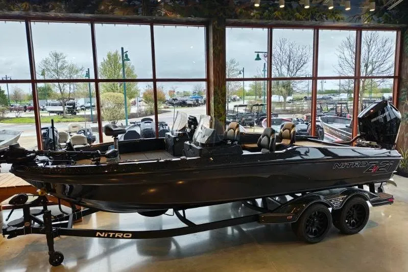 Slide: The Image of 2026 Nitro ZV21 boat displayed indoors with large windows in the background. - 10