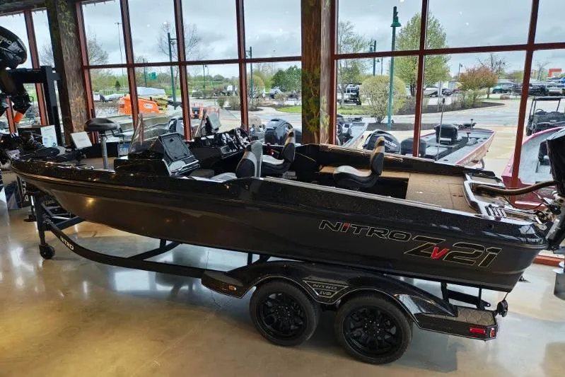 Slide: The Image of 2026 Nitro ZV21 boat displayed indoors with large windows in the background. - 11