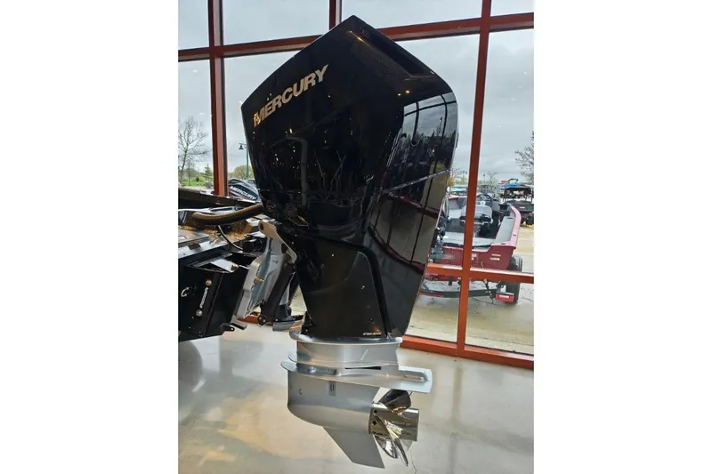 Slide: The Image of 2026 Nitro ZV21 boat with Mercury outboard motor displayed indoors. - 14