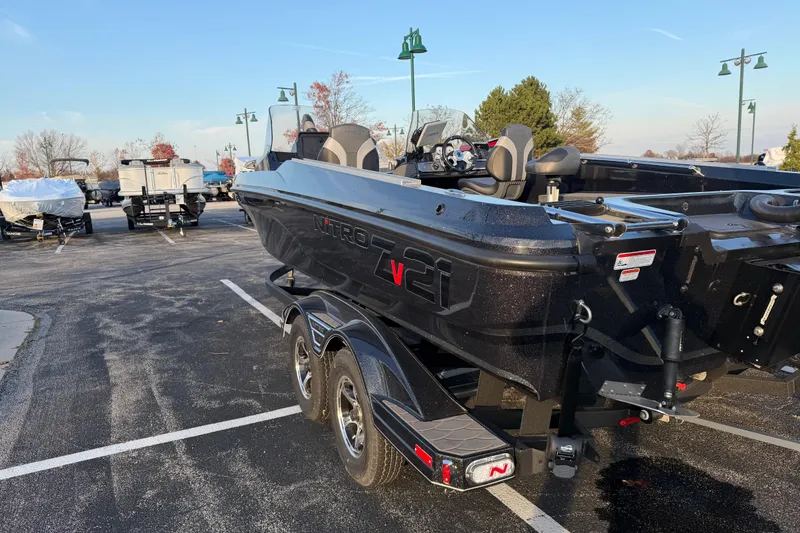 Slide: The Image of 2026 Nitro ZV21 boat on trailer in parking lot, ready for transport. - 2