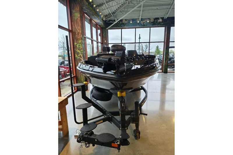 Slide: The Image of 2026 Nitro ZV21 boat displayed indoors with trailer, surrounded by large windows. - 23