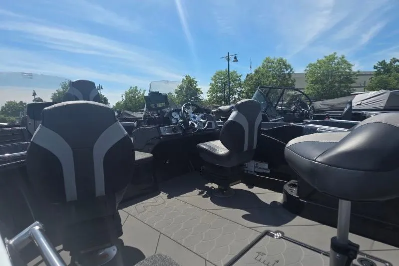 Slide: The Image of 2026 Nitro ZV21 boat interior with modern seating and steering, under a clear blue sky. - 25