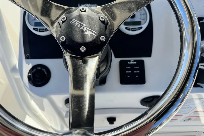 Slide: The Image of Steering wheel of 2026 Mako 214 Center Console boat with control panel. - 10