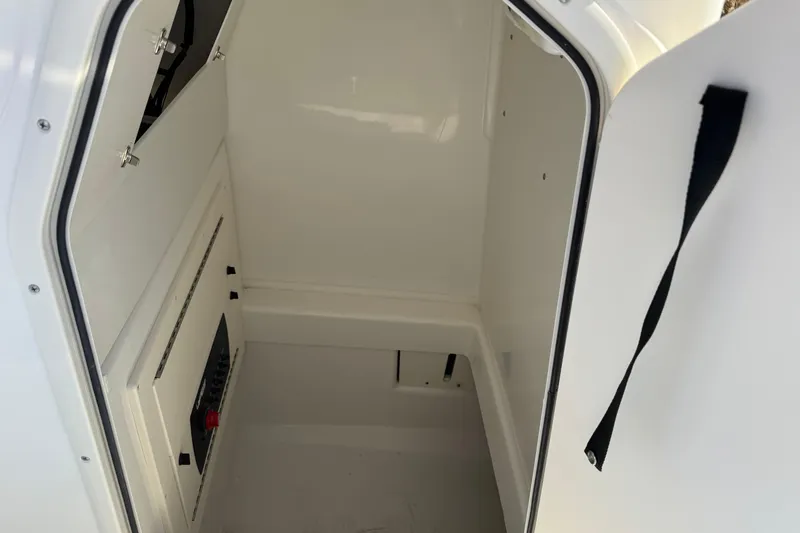 Slide: The Image of Interior view of 2026 Mako 214 Center Console boat's storage compartment. - 5