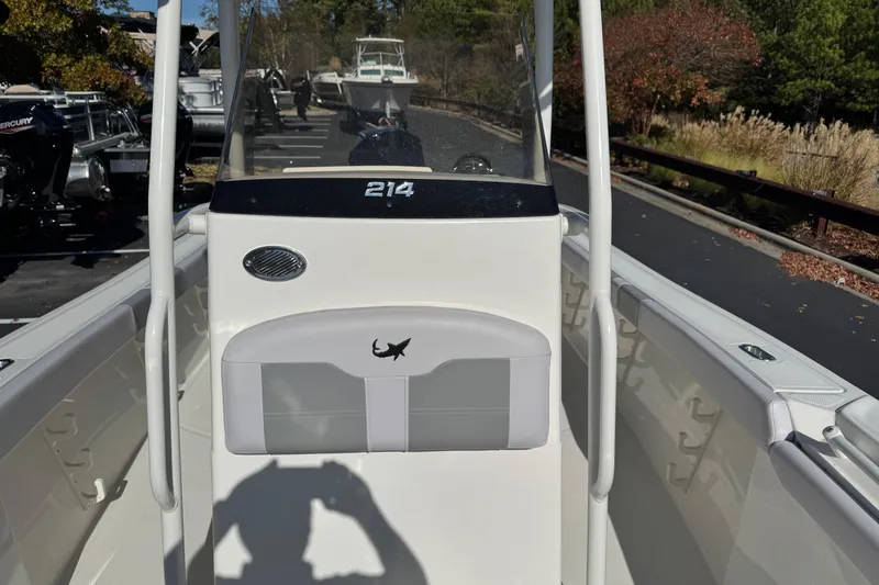 Slide: The Image of 2026 Mako 214 Center Console boat, white interior, outdoor display setting. - 6