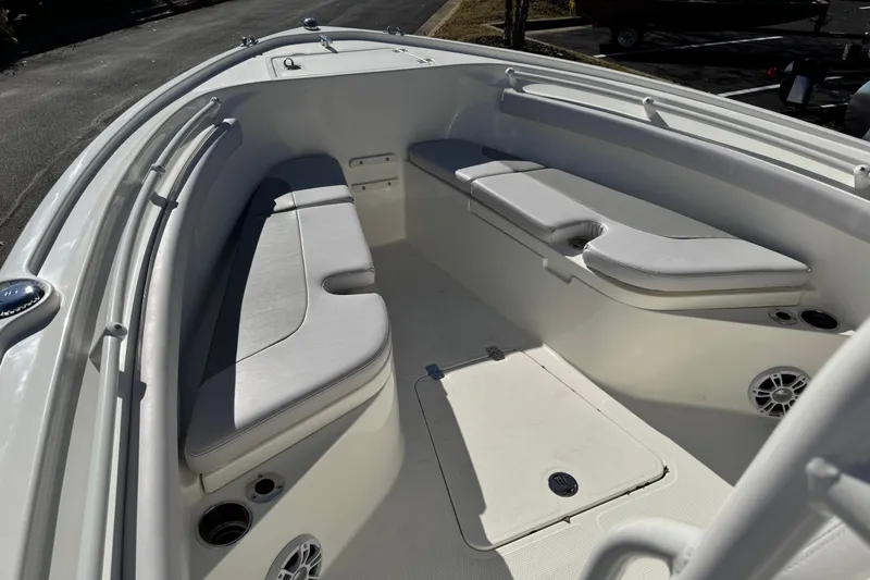 Slide: The Image of 2026 Mako 214 Center Console boat interior with cushioned seating and storage compartments. - 7