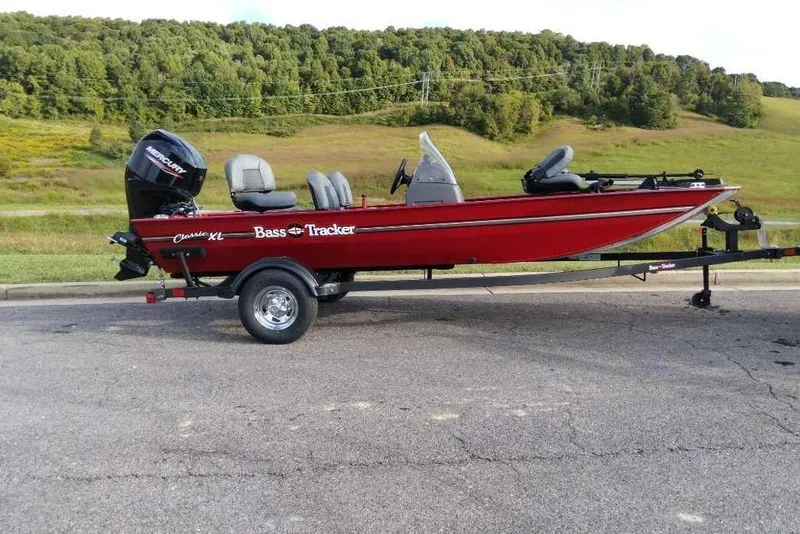 The Image of 2026 Tracker Bass Tracker Classic XL boat on trailer, parked on roadside with scenic background. - 0