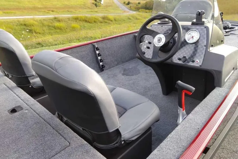 Slide: The Image of 2026 Tracker Bass Tracker Classic XL boat interior with steering wheel and seats. - 3