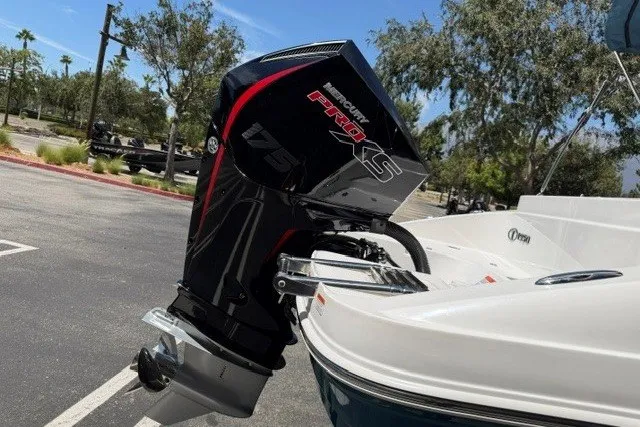 Slide: The Image of Outboard motor on a 2026 Tahoe 1950 boat, parked outdoors. - 5