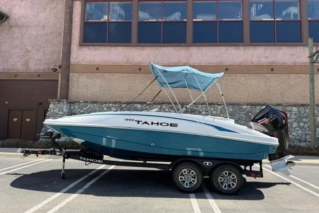 The Image of 2026 Tahoe 1950 boat with canopy on trailer, parked in a lot. - 0