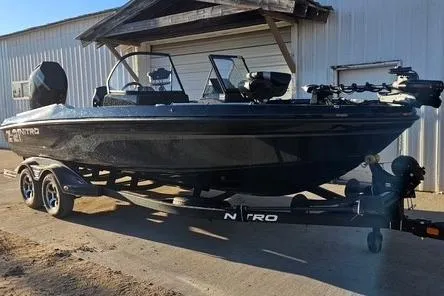 The Image of 2026 Nitro ZV21 Pro boat on trailer, parked outside a building. - 0