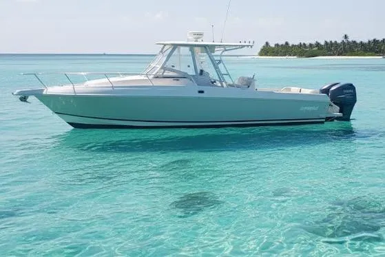 The Image of 1996 Intrepid 337 boat on clear turquoise water near tropical island. - 0