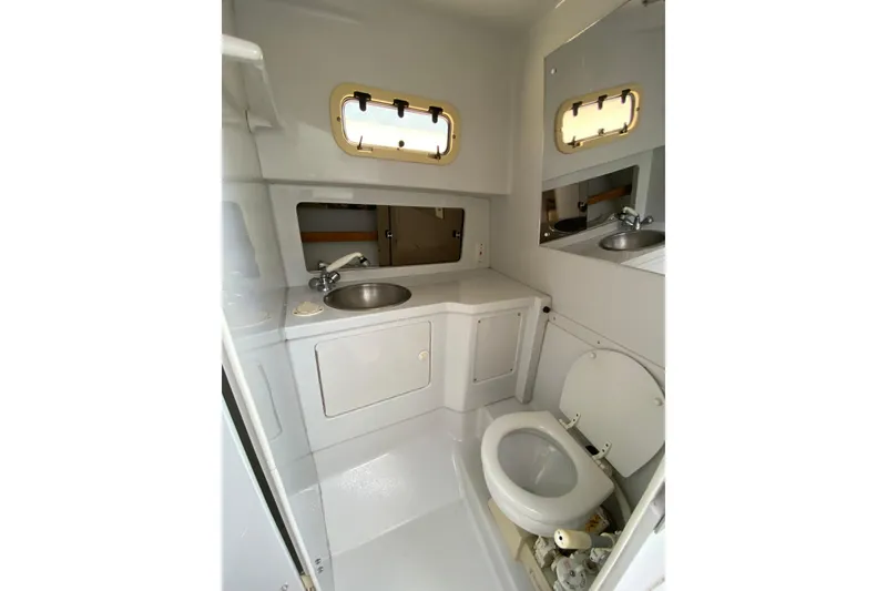 Slide: The Image of Bathroom interior of 1996 Intrepid 337 boat with sink and toilet. - 13