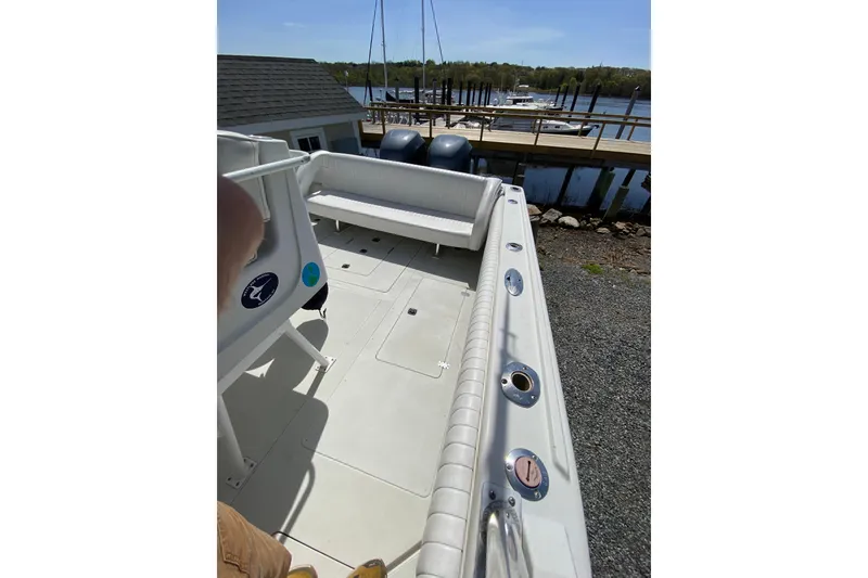 Slide: The Image of 1996 Intrepid 337 boat interior with seating, docked by a marina. - 17