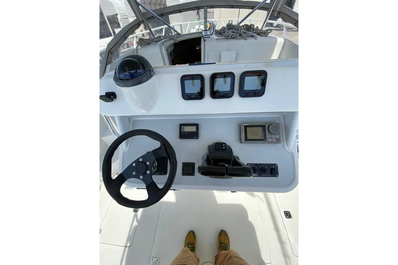 Slide: The Image of 1996 Intrepid 337 boat dashboard with steering wheel and navigation instruments. - 18