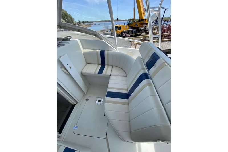 Slide: The Image of 1996 Intrepid 337 boat interior with white and blue seating, dockside view. - 19