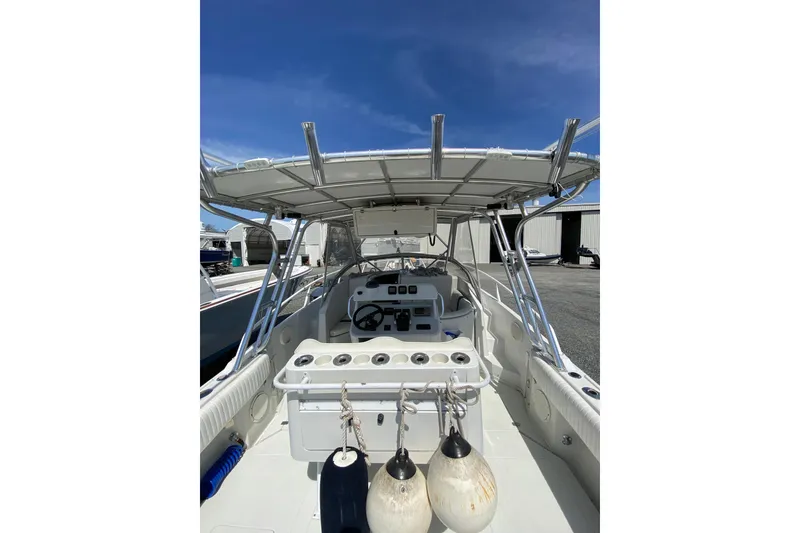 Slide: The Image of 1996 Intrepid 337 boat interior with steering console and overhead canopy. - 23