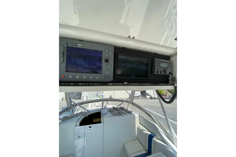 Slide: The Image of 1996 Intrepid 337 boat cockpit with navigation equipment and seating. - 24