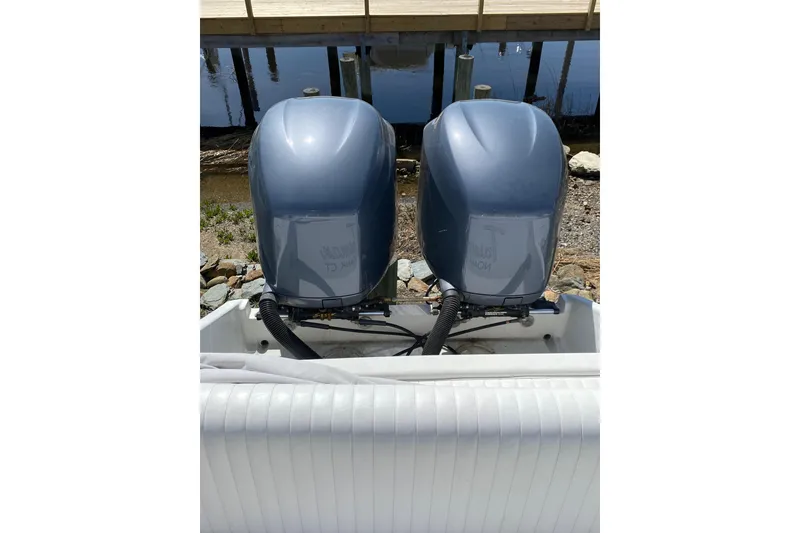 Slide: The Image of Twin outboard motors on a 1996 Intrepid 337 boat, dockside view. - 29