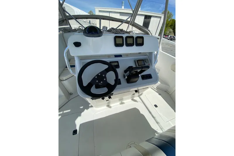 Slide: The Image of 1996 Intrepid 337 boat helm with steering wheel and navigation controls. - 32