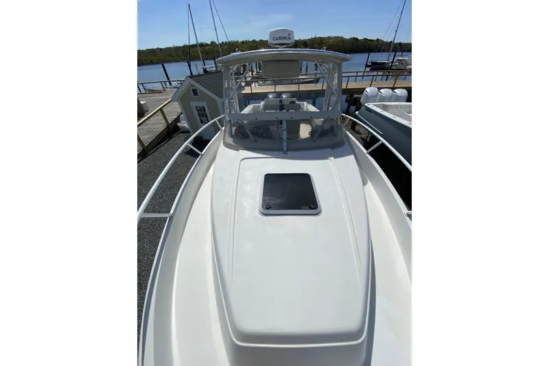 Slide: The Image of 1996 Intrepid 337 boat docked, featuring a sleek deck and Garmin equipment. - 34