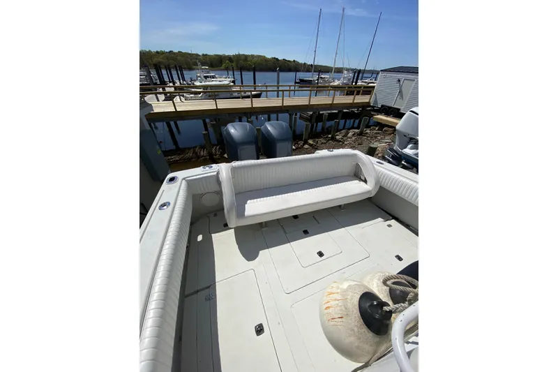 Slide: The Image of 1996 Intrepid 337 boat deck with seating, docked at marina with scenic water view. - 36