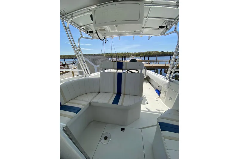 Slide: The Image of 1996 Intrepid 337 boat interior with white and blue seating, dockside view. - 37