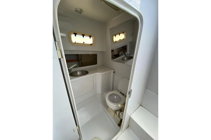 Slide: The Image of Bathroom interior of a 1996 Intrepid 337 boat, featuring sink and toilet. - 38