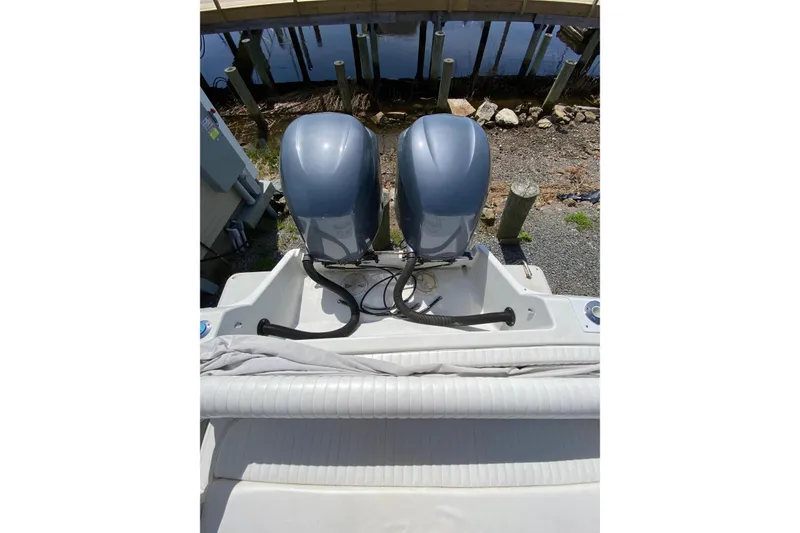 Slide: The Image of 1996 Intrepid 337 boat with dual outboard motors, docked on a sunny day. - 39
