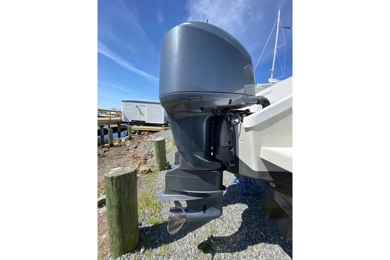 Slide: The Image of 1996 Intrepid 337 boat with a powerful outboard motor, docked on a sunny day. - 44