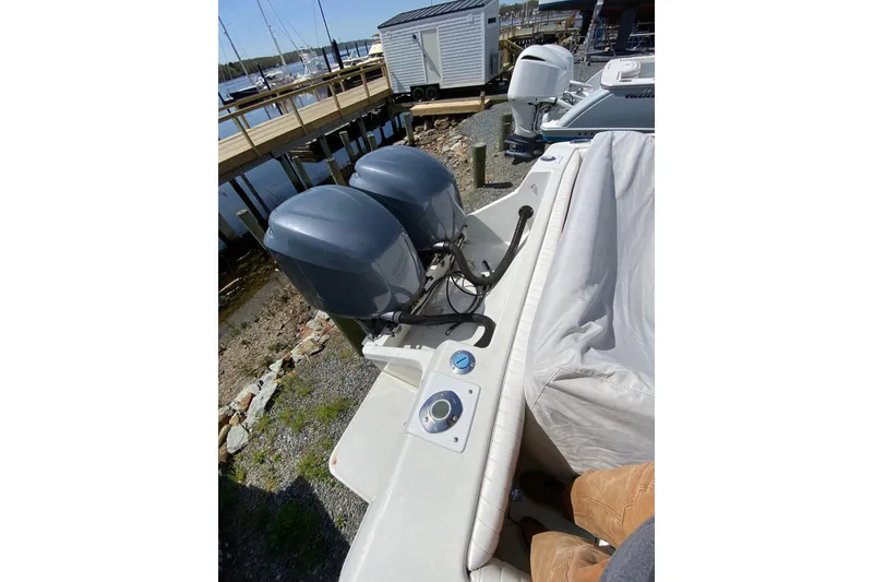 Slide: The Image of 1996 Intrepid 337 boat with dual outboard motors docked near a marina. - 45