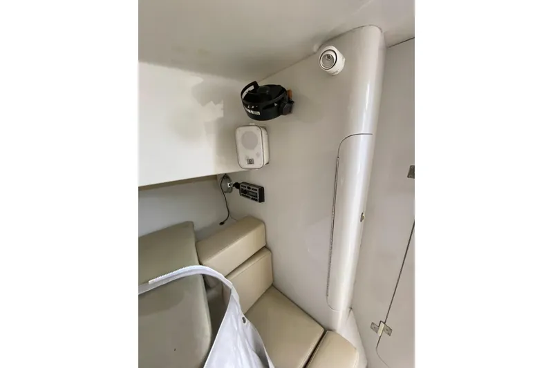 Slide: The Image of Interior of a 1996 Intrepid 337 boat, featuring seating and audio equipment. - 47