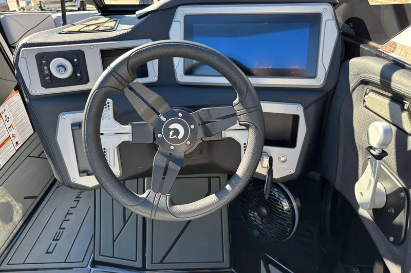 Slide: The Image of Steering wheel and dashboard of 2026 Centurion Nv243 boat, featuring modern controls and display. - 11
