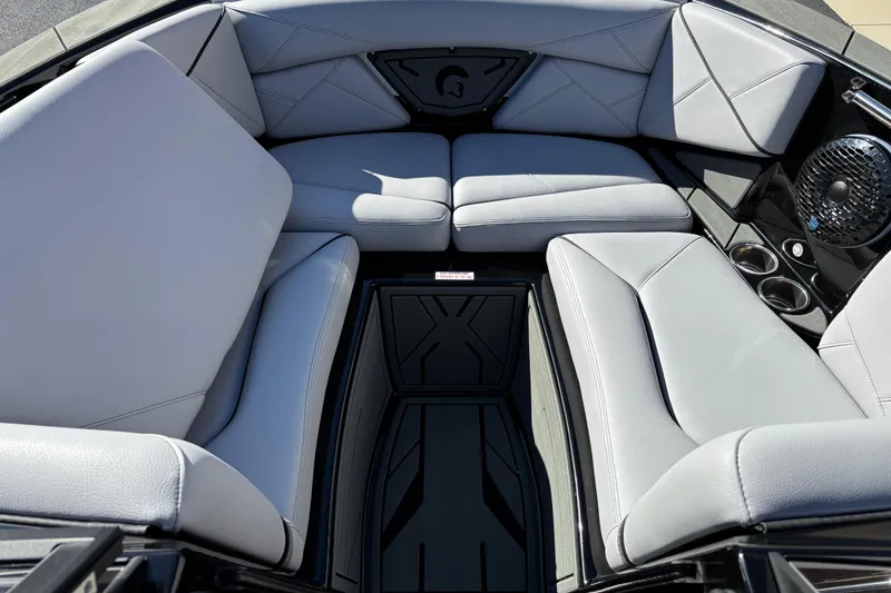 Slide: The Image of Interior of 2026 Centurion Nv243 boat with luxurious seating and cup holders. - 6