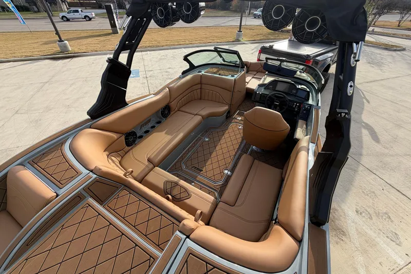 Slide: The Image of 2026 MB B52 21 Alpha boat interior with tan seating and diamond-patterned flooring. - 11