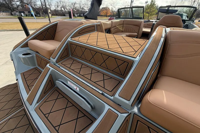 Slide: The Image of 2026 MB B52 21 Alpha boat interior with tan seating and stylish deck design. - 26