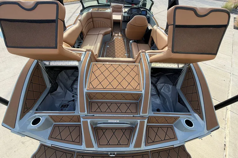 Slide: The Image of Luxury interior of 2026 MB B52 21 Alpha boat with tan seating and storage compartments. - 32