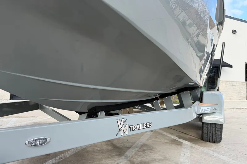 Slide: The Image of 2026 MB B52 21 Alpha boat on VM trailer, parked outdoors. - 33