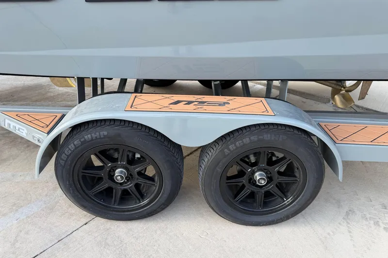 Slide: The Image of Trailer wheels of 2026 MB B52 21 Alpha boat, featuring black rims and Argus-UHP tires. - 34