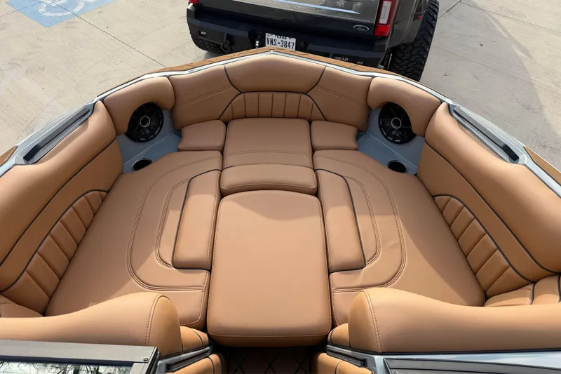 Slide: The Image of 2026 MB B52 21 Alpha boat dashboard with steering wheel and digital displays on a lake. - 8