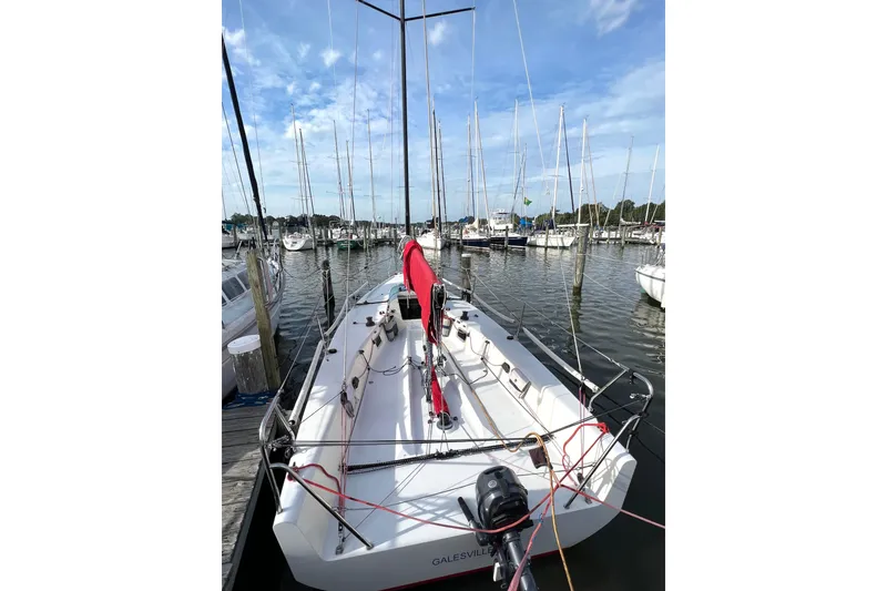 Slide: The Image of Sailboat docked at marina, 2015 Wraceboats GP26, clear sky, calm waters. - 10
