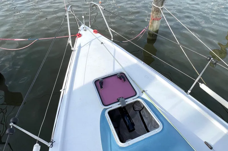 Slide: The Image of Sailboat deck of 2015 Wraceboats GP26 with open hatch, docked on calm water. - 13