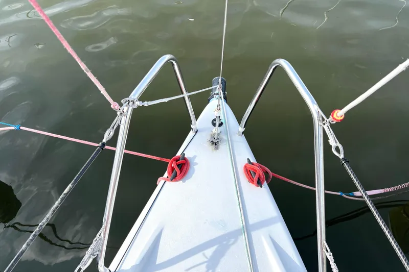 Slide: The Image of Bow of 2015 Wraceboats GP26 sailboat with ropes and metal railings. - 16